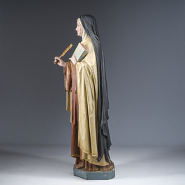 A large polychrome decorated plaster figure of Saint Teresa of Avila with glass eyes, 19th/20th C.