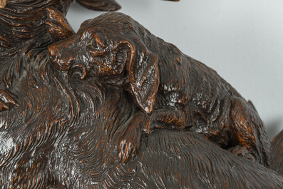 A large carved wooden 'Black Forest' clock with a deer hunt on a console tabel with floral design, 19th/20th C.