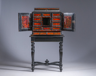 An ebonized wooden and tortoiseshell-veneered Antwerp cabinet on stand, 17th C. and later