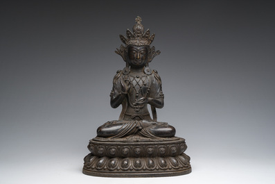 A Sino-Tibetan patinated bronze figure of Buddha, 20th C.