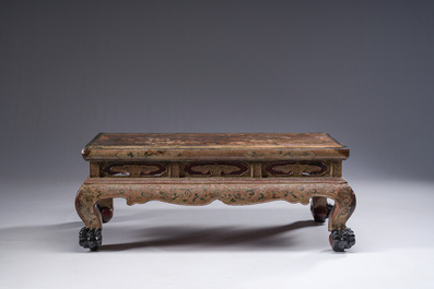 A Chinese rectangular carved and lacquered wooden low table with peach design, Qing