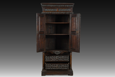 A French Gothic Revival carved wooden cabinet with two doors and two drawers with a fleur-de-lis design, 19th C.