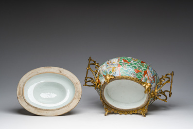 A Chinese Canton famille rose gilt mounted tureen and cover with animated scenes resting on four elephant heads, 19th C.