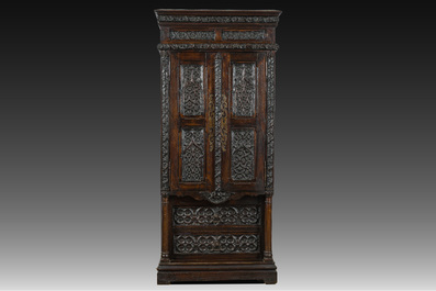 A French Gothic Revival carved wooden cabinet with two doors and two drawers with a fleur-de-lis design, 19th C.