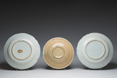 A pair of Dutch Delft blue and white dishes with a building in a landscape and a polychrome plate with a fruit basket, 18th/19th c.