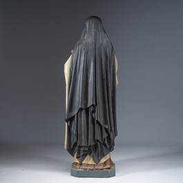 A large polychrome decorated plaster figure of Saint Teresa of Avila with glass eyes, 19th/20th C.