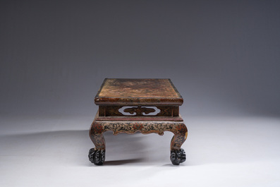 A Chinese rectangular carved and lacquered wooden low table with peach design, Qing