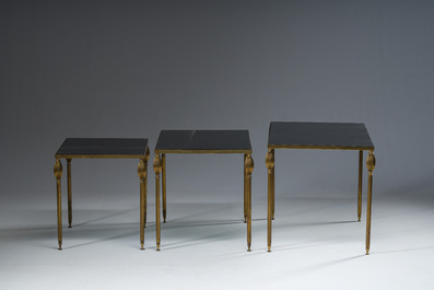 Three French Maison Jansen style brass nesting tables with fluted legs and mirrored glass tops, 1960s