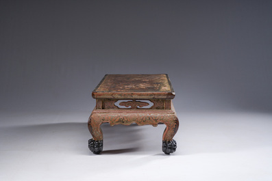 A Chinese rectangular carved and lacquered wooden low table with peach design, Qing