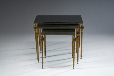 Three French Maison Jansen style brass nesting tables with fluted legs and mirrored glass tops, 1960s