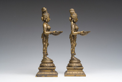 A pair of Indian oil lamps in the shape of Deepalakshmi with a bowl in her hands, 20th C.