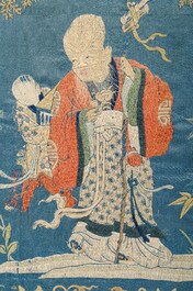 A Chinese horizontal silk embroidery with the 'Star God' Shou Xing and his servant in a landscape, 19th C.