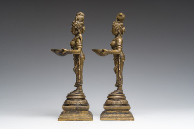 A pair of Indian oil lamps in the shape of Deepalakshmi with a bowl in her hands, 20th C.