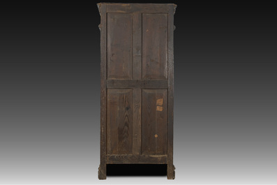 A French Gothic Revival carved wooden cabinet with two doors and two drawers with a fleur-de-lis design, 19th C.