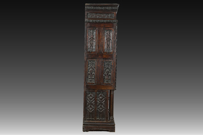 A French Gothic Revival carved wooden cabinet with two doors and two drawers with a fleur-de-lis design, 19th C.