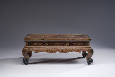 A Chinese rectangular carved and lacquered wooden low table with peach design, Qing