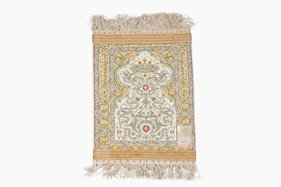 Three oriental silk rugs with hunting scenes and floral design, Hereke, Qom (Qum/Ghom) and Kashmir, 20th C.