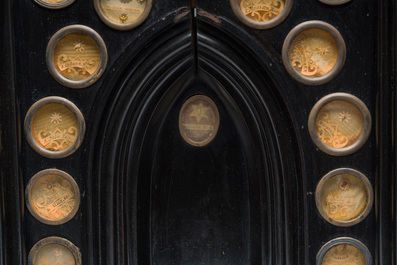 A large French Gothic Revival ebonized wooden cathedral-shaped reliquary with various relics, last quarter 19th C.