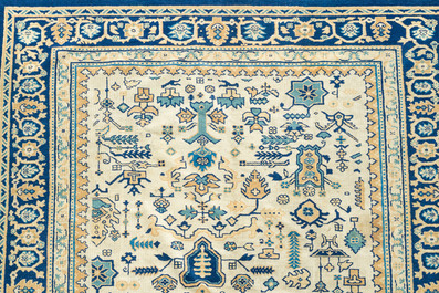 A Chinese wool carpet with floral geometric design, first quarter 20th C.