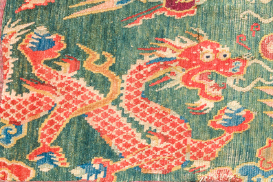 A Tibetan wool 'dragons and phoenixes' rug, 19th C.
