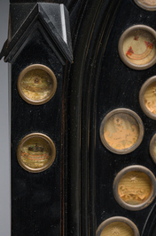 A large French Gothic Revival ebonized wooden cathedral-shaped reliquary with various relics, last quarter 19th C.