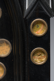 A large French Gothic Revival ebonized wooden cathedral-shaped reliquary with various relics, last quarter 19th C.