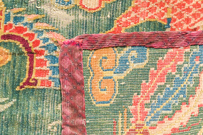 A Tibetan wool 'dragons and phoenixes' rug, 19th C.