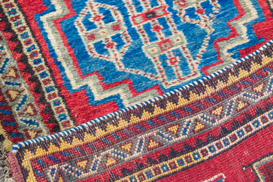 Four oriental rugs, a.o. a Persian Shirvan rug and an Azerbaijani runner with geometric design, wool on cotton, 20th C.