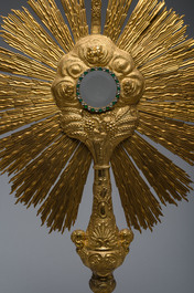 A large French gilt bronze monstrance decorated with cherubs amidst radiant clouds and set with glass stones, ca. 1900