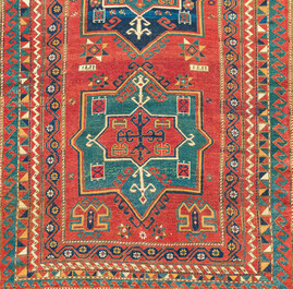 A Kazakh wool Fachralo rug with geometric and floral design, first half 20th C.