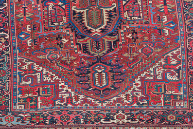 A Persian Heriz rug with floral design, wool on cotton, 20th C.