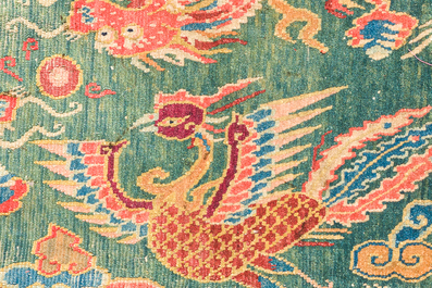 A Tibetan wool 'dragons and phoenixes' rug, 19th C.