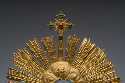 A large French gilt bronze monstrance decorated with cherubs amidst radiant clouds and set with glass stones, ca. 1900