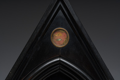 A large French Gothic Revival ebonized wooden cathedral-shaped reliquary with various relics, last quarter 19th C.