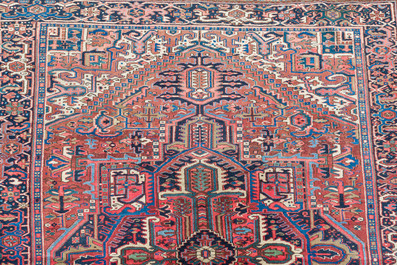 A Persian Heriz rug with floral design, wool on cotton, 20th C.