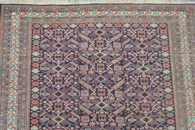 Four oriental rugs, a.o. a Persian Shirvan rug and an Azerbaijani runner with geometric design, wool on cotton, 20th C.
