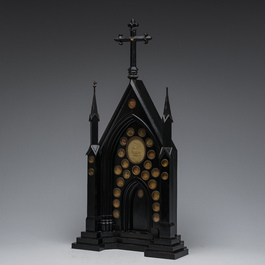 A large French Gothic Revival ebonized wooden cathedral-shaped reliquary with various relics, last quarter 19th C.