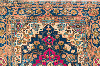 A Persian Kerman (Kirman) rug with figurative design and an Isfahan rug with floral design, wool on cotton, 20th C.