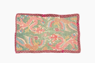 A Tibetan wool 'dragons and phoenixes' rug, 19th C.