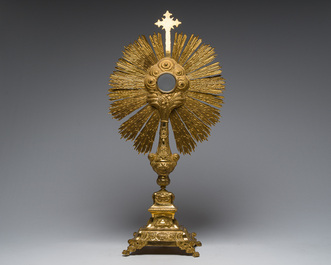 A large French gilt bronze monstrance decorated with cherubs amidst radiant clouds and set with glass stones, ca. 1900