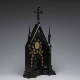 A large French Gothic Revival ebonized wooden cathedral-shaped reliquary with various relics, last quarter 19th C.