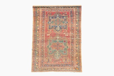 A Kazakh wool Fachralo rug with geometric and floral design, first half 20th C.