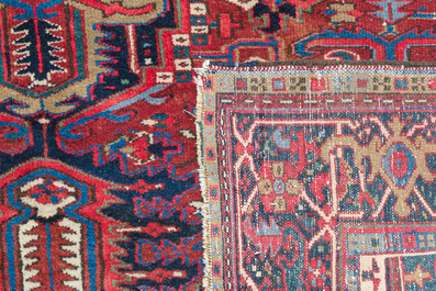 A Persian Heriz rug with floral design, wool on cotton, 20th C.