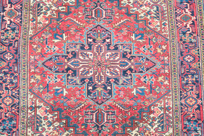A Persian Heriz rug with floral design, wool on cotton, 20th C.