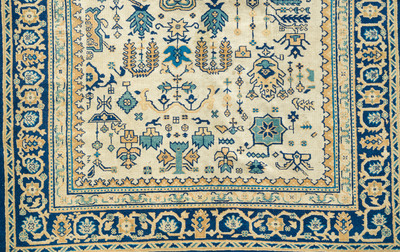 A Chinese wool carpet with floral geometric design, first quarter 20th C.