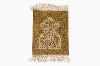 Three oriental silk rugs with hunting scenes and floral design, Hereke, Qom (Qum/Ghom) and Kashmir, 20th C.