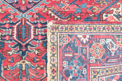 A Persian Heriz rug with floral design, wool on cotton, 20th C.