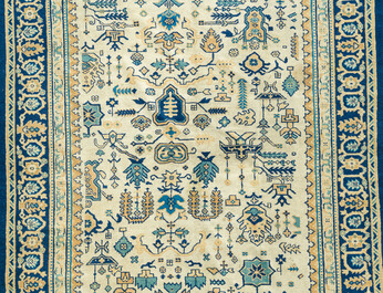 A Chinese wool carpet with floral geometric design, first quarter 20th C.