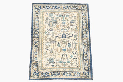 A Chinese wool carpet with floral geometric design, first quarter 20th C.