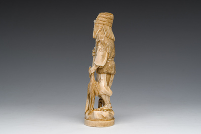 A Japanese ivory okimono of a hunter with his hunting trophy, signed, Meiji, ca. 1900